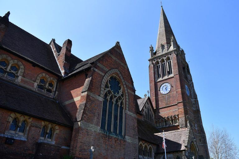 The red-brick Victorian church of St Michael and All Angels seen from Lyndhurst High Street